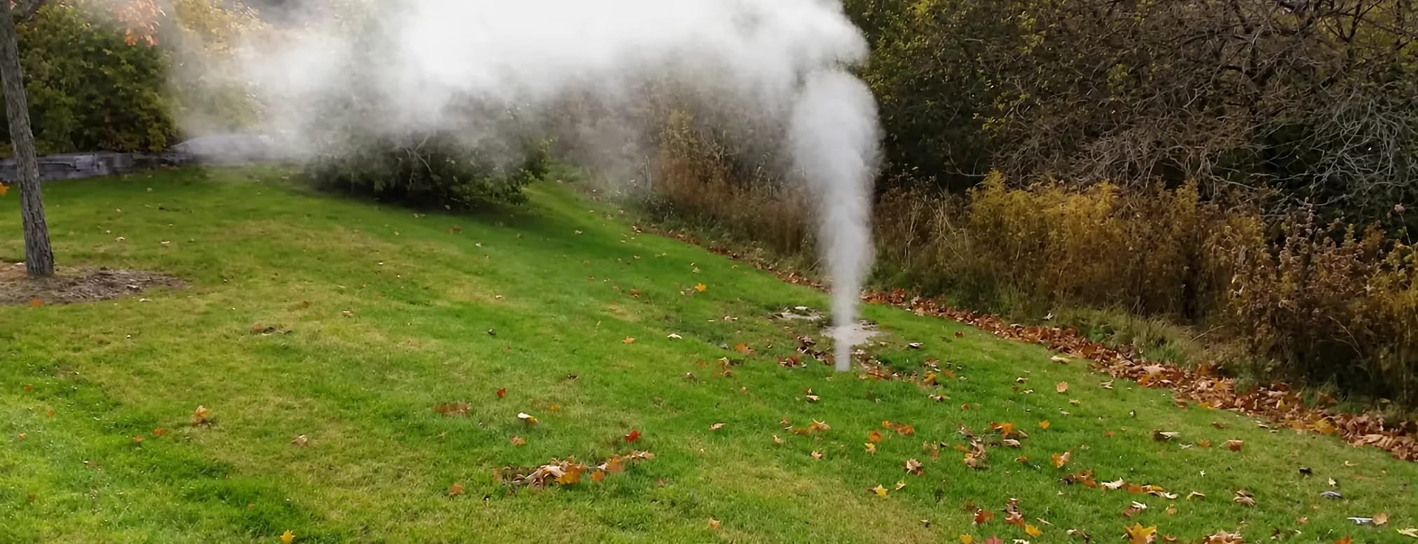 Column of smoke rising from a lawn during a smoke test